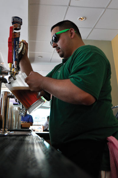Rico Dominguez pours a pitcher of beer during his shift last Wednesday. Holly Bensur // Staff Photographer