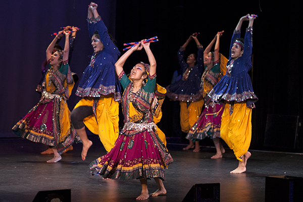 Sophomore Palna Kapadia dances with the Hurricane SwaggeRaas team at the 6th annual Miami Mayhem Intercollegiate Garba/Raas competition on Saturday night. The competition, held at the Julius Littman Performing Arts Center in North Miami Beach, featured Indian dance teams from across the country. Dandiya Raas is a traditional Indian dance performed to honor the Goddess Amba during the annual Navaratri festival. The dance incorporates hitting sticks together to maintain a steady beat. The winning team was Dirty South Dandiya from the University of Texas. Monica Herndon // Assistant Photo Editor