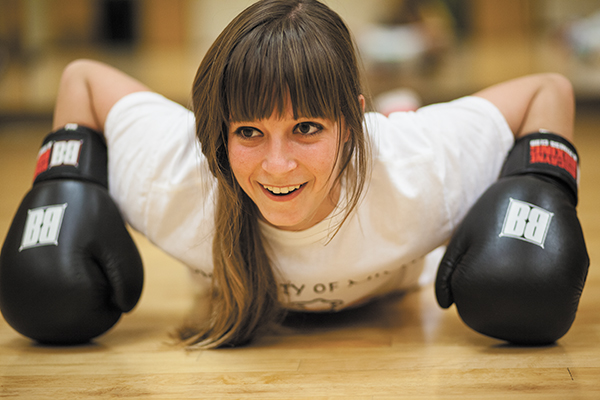 Freshman Teresa Browning takes a break during the boxing club practice on Thursday night in the Wellness Center. Browning is the club president for this semster, and will be returning as president next year. Most of the club members use boxing as a way to get into shape. Monica Herndon // Assistant Photo Editor