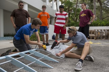 UM Engineering students work on completing their aircraft on Wednesday afternoon that will take flight at Redbull Flugtag on Saturday. The event, held at Bayfront Park in Downtown Miami, brings together teams that construct homemade aircraft and fly them from an elevated barge into the ocean, aiming to fly the furthest distance. Last year's team won the "People's Choice Award" for their Angry Birds themed craft. Vote for this year's team by texting "MIA15" to 72855 (voting opens at noon today). Nick Gangemi // Assistant Photo Editor