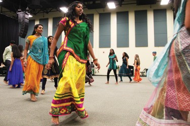 The Fieldhouse at Bank United Center was bursting with Indian tradition Friday night. The UM's Indian Students Association and Hindu Students Council welcomed students to dance Garba, a traditional dance performed around a centrally lit lamp or statue of the Goddess Shakti. Men and women twirled around the room all night long, the spiritual dance is performed in a circle to symbolize the Hindu view of time. The night was colorful as women paraded their most beautiful Sari, Ghagra Choli and Salwars and everyone enjoyed delicious indian cuisine. Michelle Brener // Contributing Photographer 