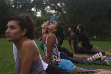 Sophomore Nikhita Allam participates in a Vinyasa flow class on September 5th for Yoga on the Green--a University of Miami initiative that hosts free yoga classes every Thursday for members of the Coral Gables community. Torie O’Neil // Contributing Photographer