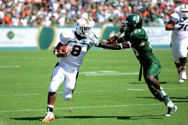 Sophomore Duke Johnson (8) avoids a USF defender during the game Saturday afternoon in Tampa. The Canes won 49 to 21. Photo courtesy Tony Gordon for the USF Oracle.