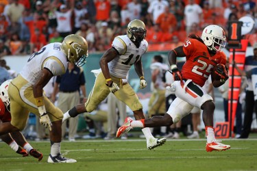 Sophomore Dallas Crawford (25) runs the ball during the game against Georgia Tech on Saturday at Sunlife stadium. Monica Herndon // Photo Editor