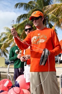 Dr. Neil Hammerschlag explains to UM alumni how to deploy the fishing gear, during a shark tagging trip on November 10th out of key biscayne FL, during alumni weekend. RJD uses a drumline system utilizing a shark friendly circle hook. Photo courtesy Cat Schulz
