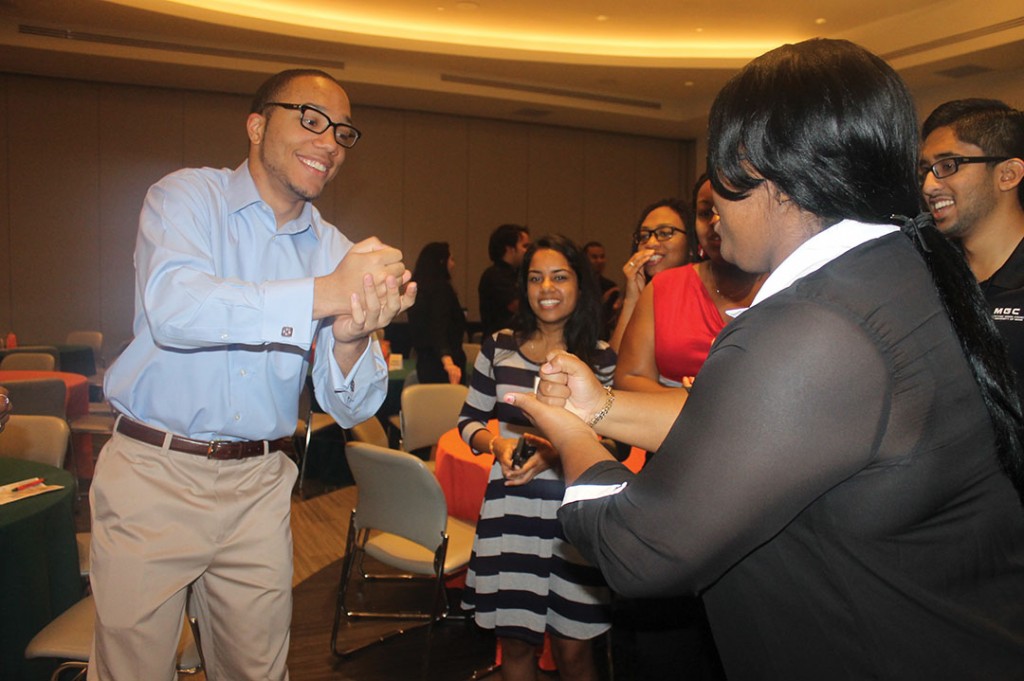 Jackson Bowser, a freshman, and Arlisia Ables, a junior, go fist-to-fist in a game of rock, paper, scissors during 'Canes Lead. The game was used as an icebreaker during the leadership conference, to help students feel more comfortable around each other. Ashley McBride // Contributing Photographer