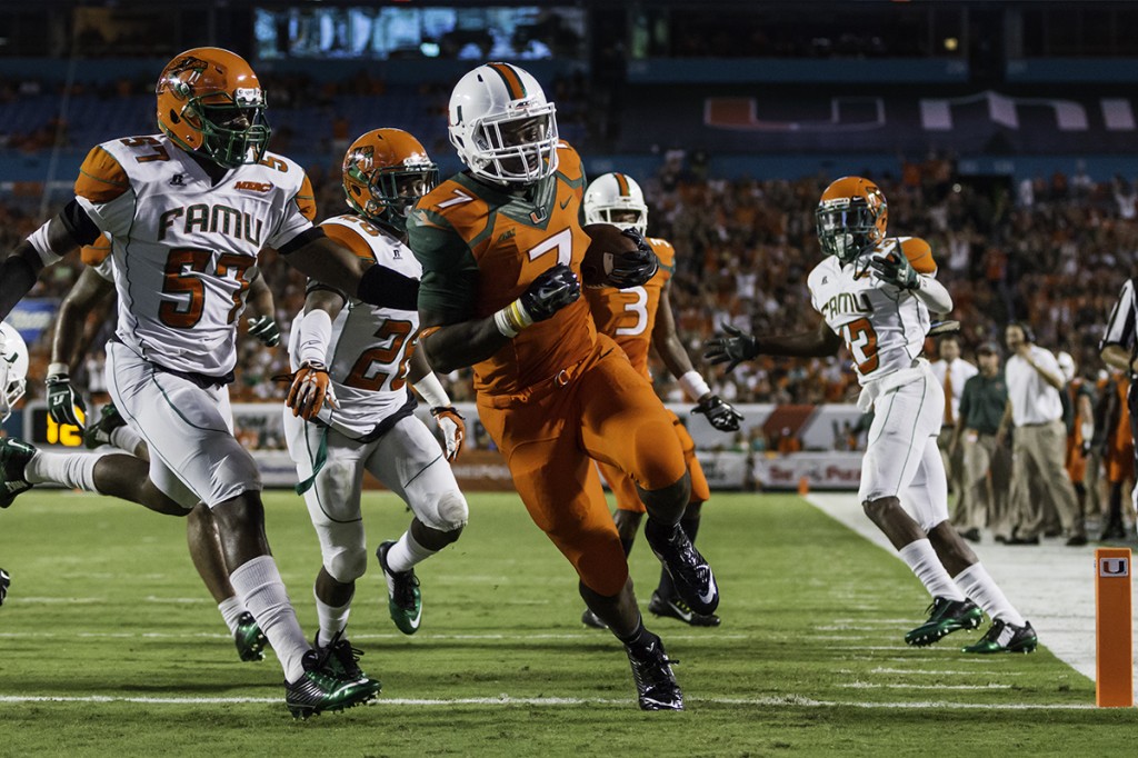 Sophomore Gus Edwards runs past Florida A&M defenders and scores a running touchdown during the second quarter of Saturday night’s game. Nick Gangemi // Photo Editor