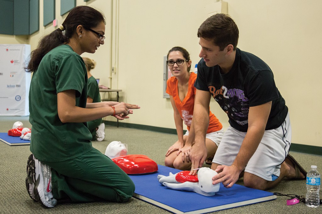 Accelerated BSN Senior Neha Chauhan certifies graduate student Cari Eckman and alum Mike Anderson to preform CPR during Saturday’s CPR Day event held at the BUC Fieldhouse. Nick Gangemi // Photo Editor