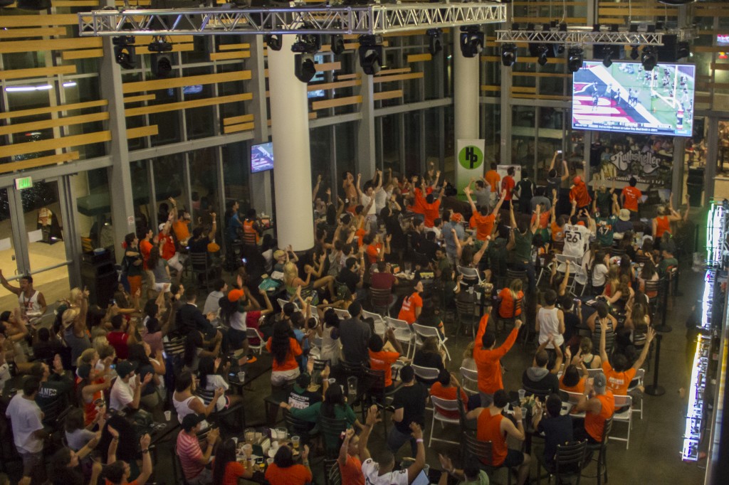Students celibrate a touchdown during the Rat watch party for the Hurricanes' season opener against Louisville on Saturday. Victoria McKaba // Staff Photographer