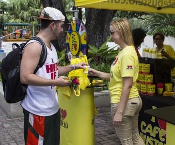 Junior Jesse Schilling grabs free coffee and a shirt from Cafe Bustelo on the Rock Tuesday. Cafe Bustelo promoted its scholarship program, which recently became eligible to Hispanic students. Giancarlo Falconi // Staff Photographer