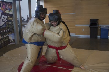 Seniors Julie Earl and Jesus Melendez sumo wrestle during the Hurricane Productions event on Monday evening at the Rat. A food eating contest also took place. Victoria McKaba // Staff Photographer