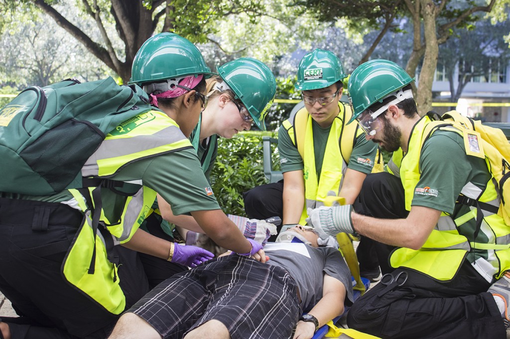 Members of the Canes Emergency Response Team (CERT) attend to a victim during a simulated disaster readiness exercise held on Sunday afternoon outside of the Dooley Memorial building. Giancarlo Falconi // Staff Photographer