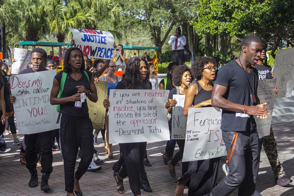 Various student groups organized a “#BlackLivesMatter” demonstration that took place on campus Wednesday afternoon. Protestors marched around campus, staged a “die in” on the rock, and hosted a guest speaker. Giancarlo Falconi // Staff Photographer