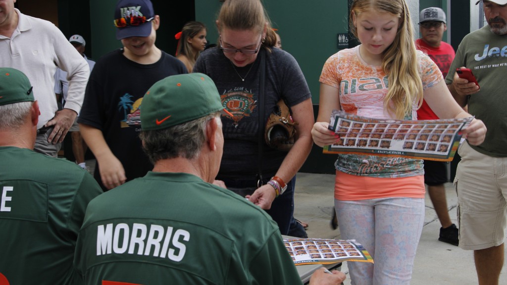 Coach Jim Morris autographs Hurricanes Baseball posters for fans at the 2014 FanFest. Lyssa Goldberg // Online Editor
