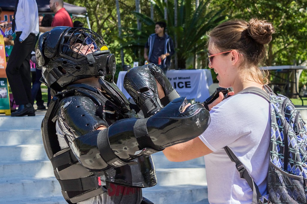 Freshman Felicia Amon spars with another UM student, who is wearing a “dynamic simulation training suit,” during the University of Miami Police Department’s 45th anniversary celebration. During the event, which took place on the Rock Wednesday, UMPD gave out cupcakes, recruited students to join a self defense group and recognized outstanding members of the UM community for their heroic efforts. Giancarlo Falconi // Staff Photographer