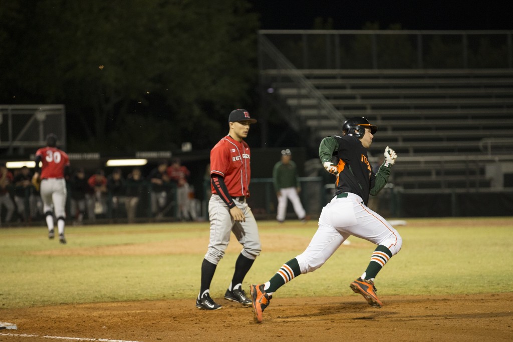 Junior third baseman David Thompson rounds first base in a first inning triple Saturday night at Mark Light Field in the third game versus Rutgers. Canes beat Rutgers 9-3, holding onto their ninth rank in the country. Matthew Trabold // Staff Photographer