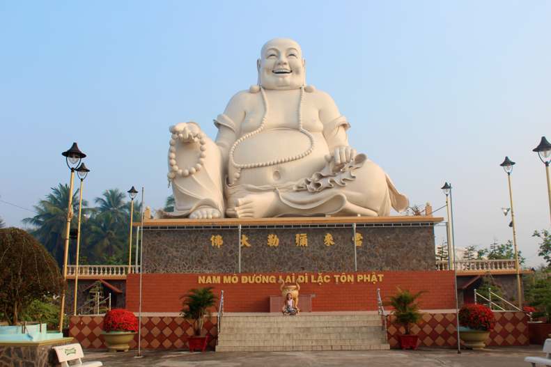 Jamie Servidio poses in front of this giant happy buddha statue on the outskirts of Ho Chi Minh City. 