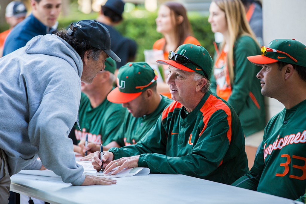 Baseball head coach Jim Morris signs posters and other memorabilia for fans during February’s Fan Fest held at Alex Rodriguez Park at Mark Light Field to open the 2015 season. File Photo by Nick Gangemi