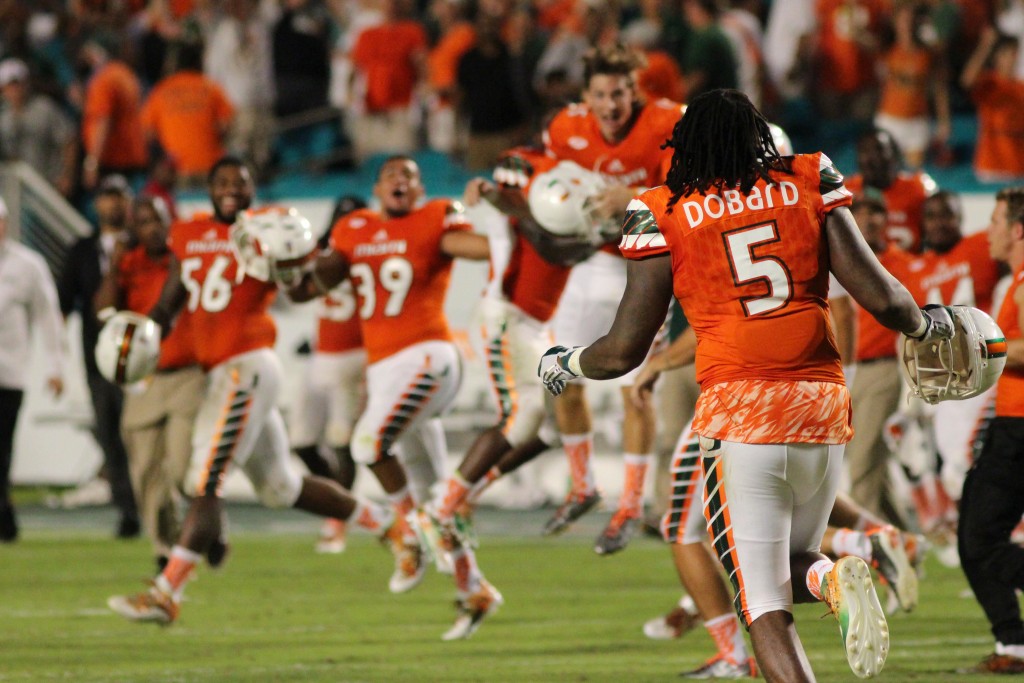 The Canes storm the field after their overtime win against Nebraska. Hallee Meltzer // Photo Editor