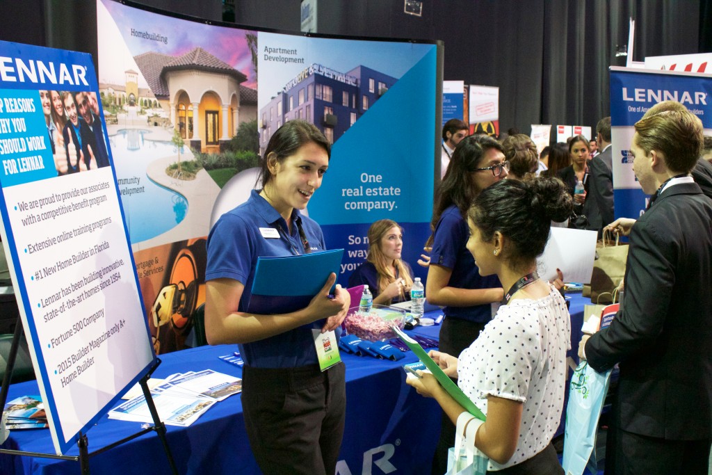 Freshman Diaya Tulshi speaks to a representative from Lennar, a home development company which focuses on multigenerational living, at the Career Expo Friday afternoon. Kawan Amelung // Contributing Photographer 