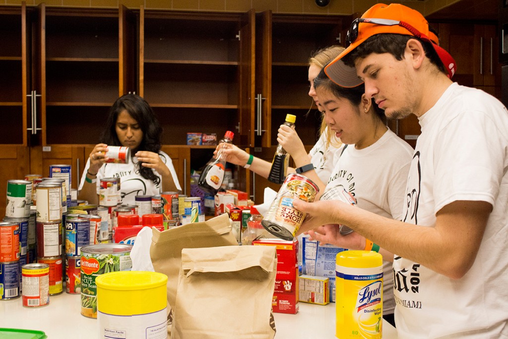 (Left to right) Sophmores Neha Bhaskar, Geena Marzouca, Alyce Kuo, and Aaron Gluck, of the Alpha Phi Omega service fraternity, restock the kitchen and filter out expired food at the Ronald McDonald House Saturday. Shreya Chidarala // Assistant Photo Editor