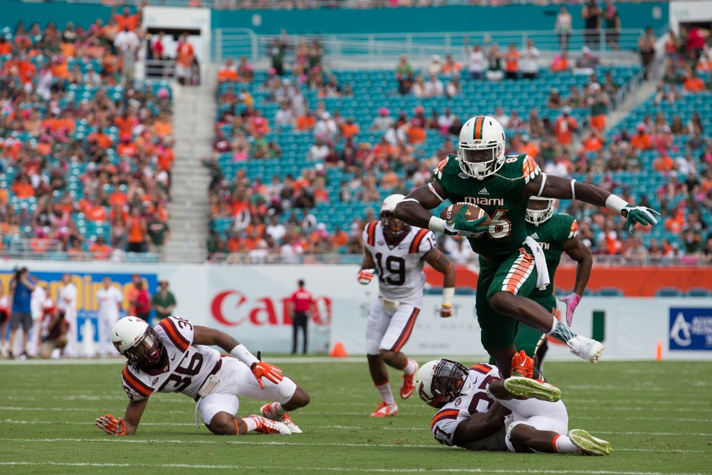 Tight end David Njoku (86) runs over a Virginia Tech defender in the Hurricanes' 30-20 win over the Hoakies last Saturday. Miami takes on Clemson this Saturday at Sun Life Stadium. Matthew Trabold // Staff Photographer