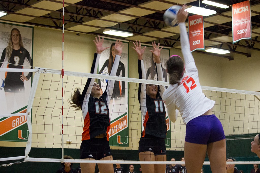Sophomore Olga Strantzali (12) and freshman Lucia Pampana (11) block a spike during the second set of Sunday's volleyball game against Clemson University. The Canes won 3-0. Giancarlo Falconi // Assistant Photo Editor 