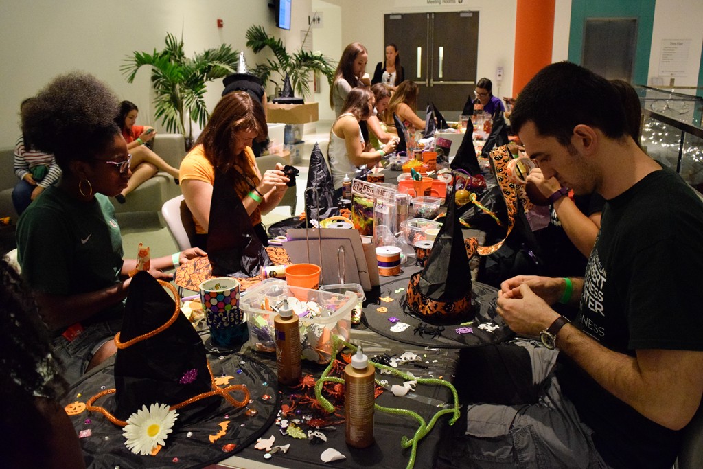 During this month's Halloween-themed Canes After Dark, students design their own witch hats Friday evening. Additional entertainment included a fortune teller and henna designer. Evelyn Choi // Contributing Photographer