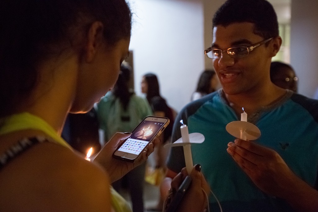 Students share images to social media of the candelight vigil Wednesday evening in the UC Breezeway. Nick Gangemi // Editor in Chief
