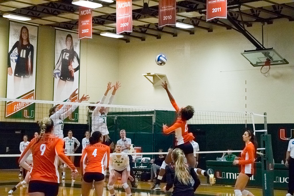 Senior outside hitter Taylor Scott (22) reaches for the ball during Sunday's 3-1 win over Notre Dame. The Canes bounced back after a 3-1 loss to Louisville on Friday. Evelyn Choi // Staff Photographer