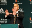 After the press conference announcing his hire, Mark Richt, University of Miami’s newest head football coach, throws up the “U” Friday morning in the Shalala Student Center. Erum Kidwai // Staff Photographer