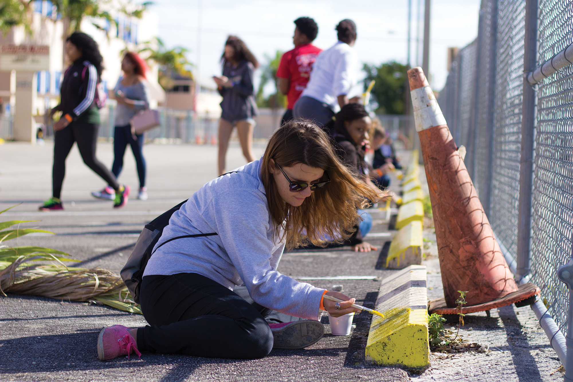 Freshman Tamara Popovska paints a parking spot alongside other students volunteering for the Martin Luther King Jr. Day of Service in Liberty City on Monday. The MLK Day of Service experienced a record turnout with nearly 150 student volunteers. UM partnered with the Miami Children’s Initiative to bring volunteers to elementary and middle schools in Liberty City, where the volunteers worked on beautifying the area. Some of the projects included painting, laying mulch and cleaning up. The volunteers also got to spend time playing sports with children from local neighborhoods. Kawan Amelung // Staff Photographer