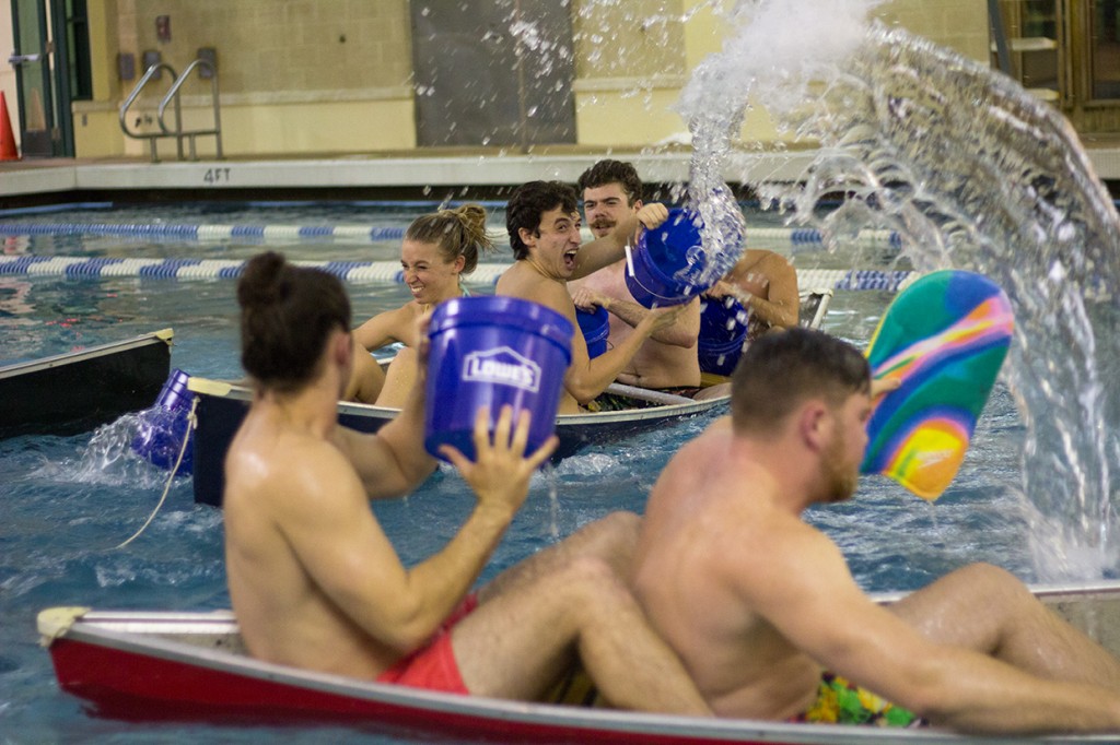 Freshman Nick Hartman throws water at an opposing team during Friday's Battleship tournament at the Wellness Center pool. Teams aimed to sink the canoes of opponents using these buckets of water. Kawan Amelung // Staff Photographer
