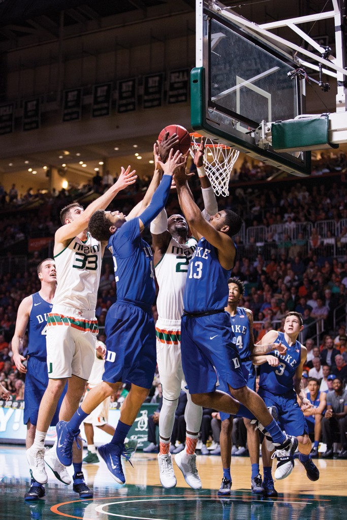 Senior center Tonye Jekiri and senior forward Ivan Cruz Uceda challenge two Duke players for a rebound during Monday night’s game at the BankUnited Center. The Hurricanes won the game 80-69, improving their record to 16-3. Nick Gangemi // Editor-in-Chief
