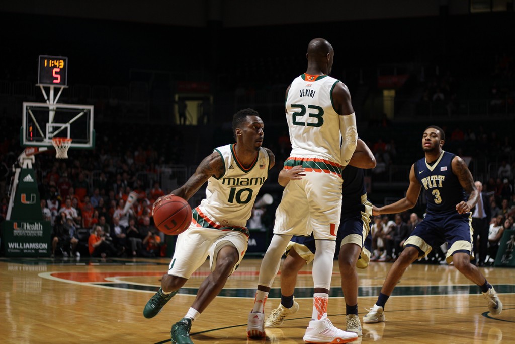 Redshirt senior guard Sheldon McClellan (10) dribbles around players in order to charge to the net during the Hurricanes 65-63 win over Pittsburgh Tuesday night at the BankUnited Center. Kawan Amelung // Staff Photographer