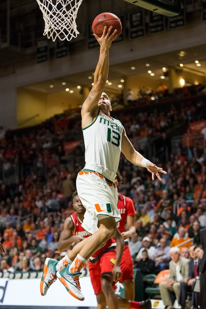 Redshirt senior guard Angel Rodriguez jumps for an uncontested layup during Saturday afternoon's men's basketball game against Louisville. The Hurricanes defeated the Cardinals 73-65. Nick Gangemi // Editor-in-Chief