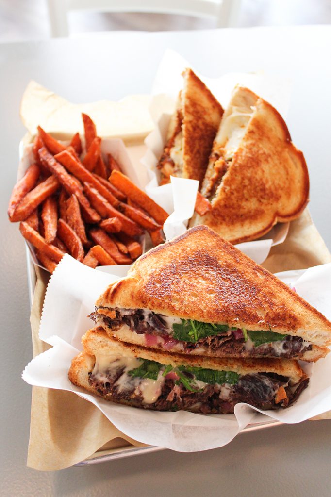 The Short Rib Melt and Buffalo Chicken Melt are two of the unique grilled cheese sandwiches available at Ms. Cheezious' second store-front location in Coral Gables. Hallee Meltzer // Photo Editor