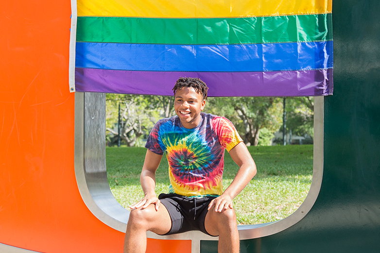 A student poses on the "U" Statue for Pride Week's Ally Photoshoot. Evelyn Choi // Staff Photographer