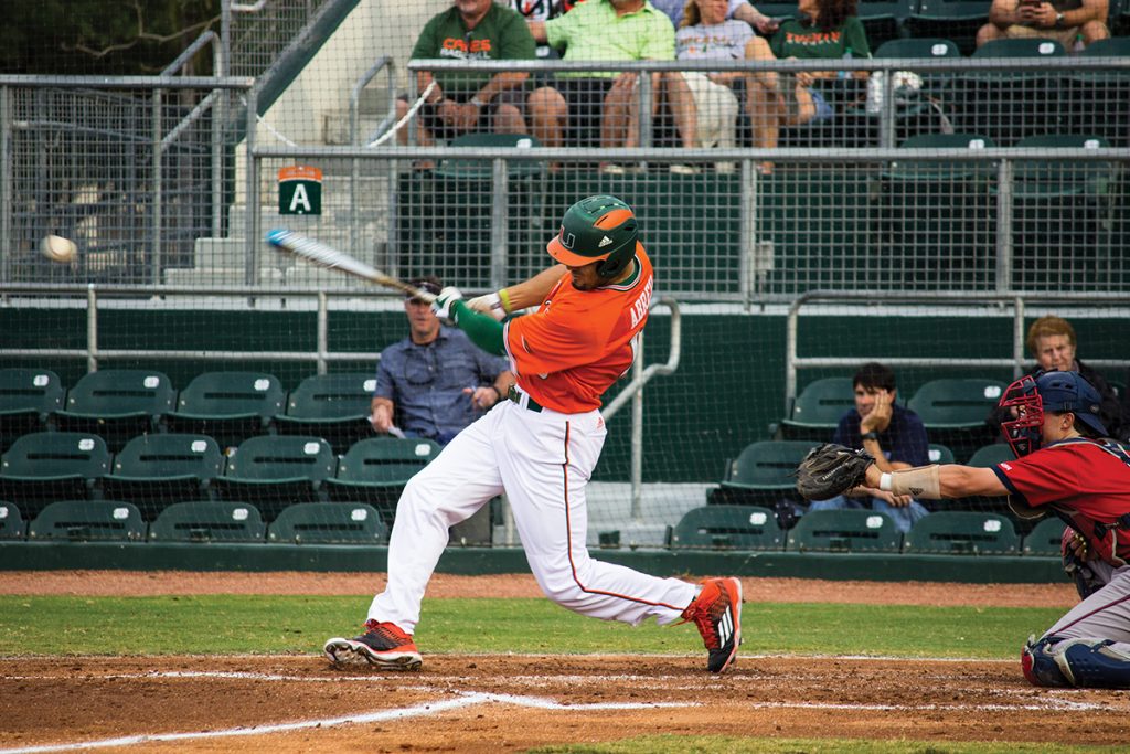 Junior outfielder Willie Abreu (13) finishes his swing at Alex Rodriguez Park at Mark Light Field Wednesday night. The Canes lost 4-3 against FAU. Giancarlo Falconi // Staff Photographer