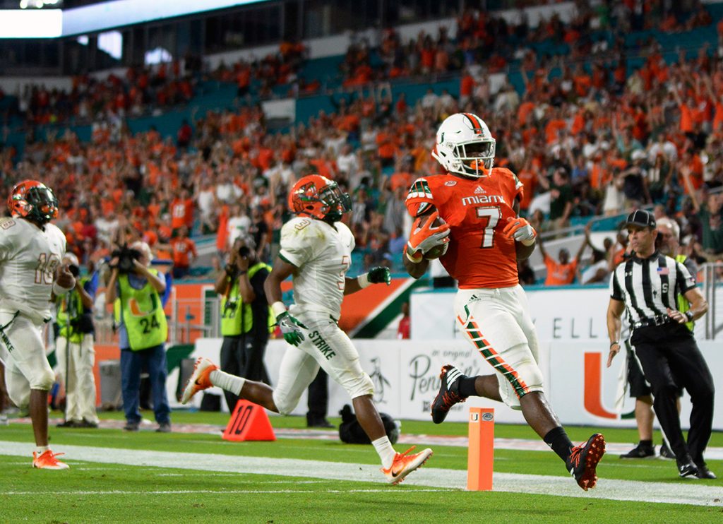 Redshirt junior running back Gus Edwards (7) glides into the end zone for a Hurricanes' touchdown during the 70-3 win over FAMU Saturday night at Hard Rock Stadium. Joshua White // Contributing Photographer