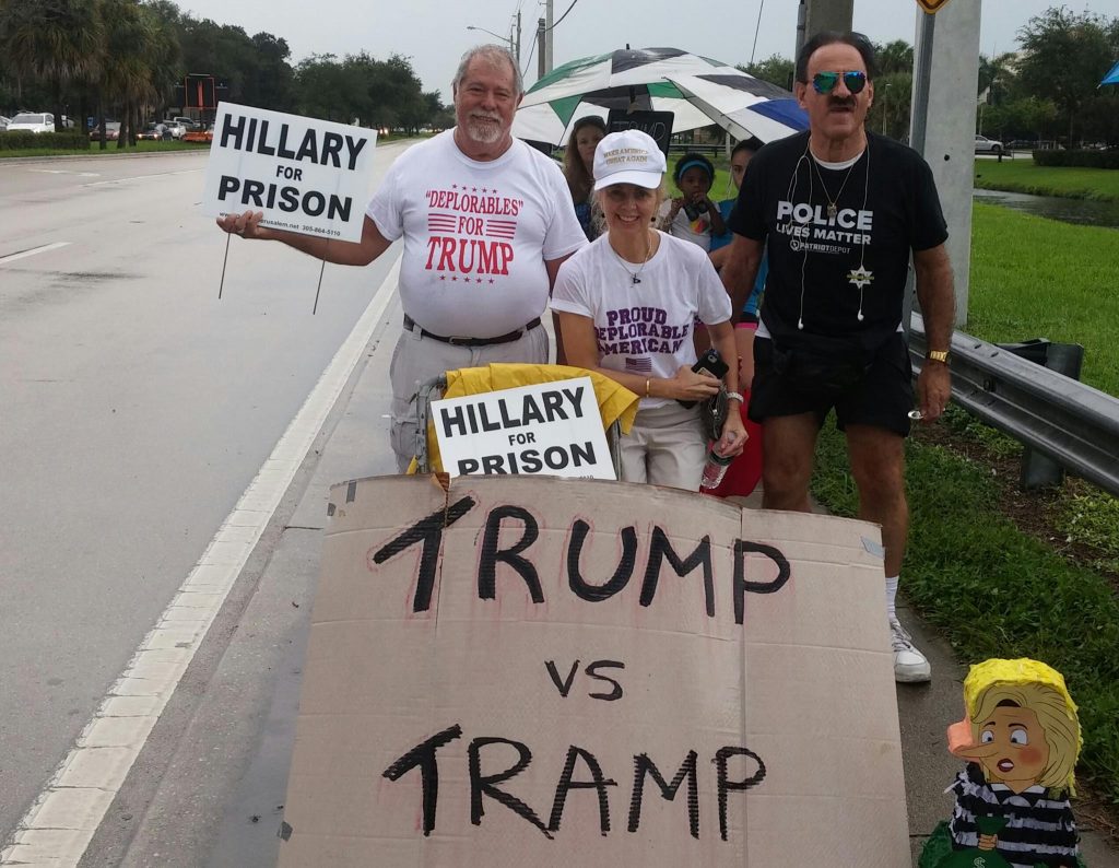 Bob Kunst (left) and Rhonda Lopez (middle) protest the Clinton rally Friday afternoon in Coral Springs. Marcus Lim // Assistant News Editor
