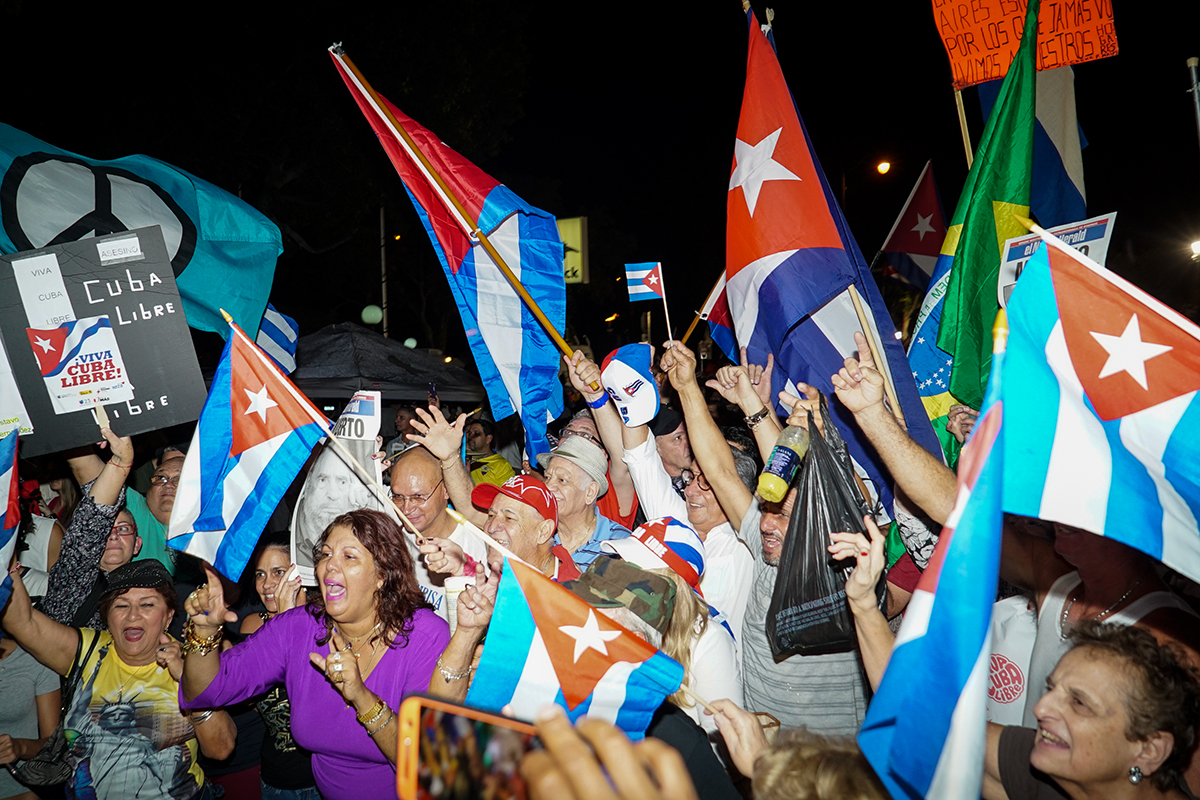 Crowds fly flags high at Wednesday's celebrations in Little Havana. Hunter Crenian // Staff Photographer