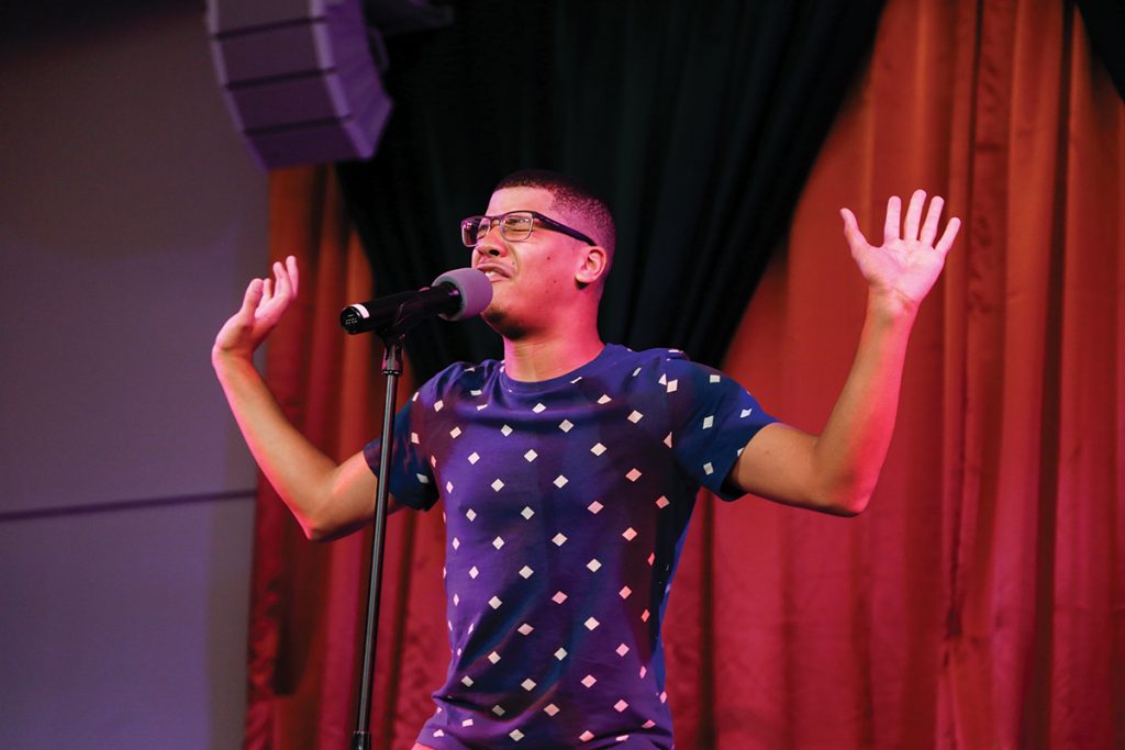 Junior Antonio Mercurius recites a poem he wrote during the King and Queen Pageant Tuesday night in the Shalala Student Center. Mercurius was named Homecoming King and represents the organization United Black Students. Evelyn Choi // Staff Photographer 