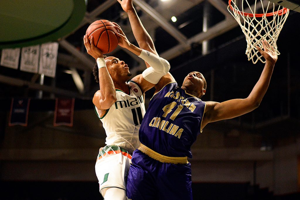 Freshman guard Bruce Brown (11) goes for a layup during Friday's season opener against Western Carolina at Watsco Center. The Canes won 92-43. Josh White // Staff Photographer
