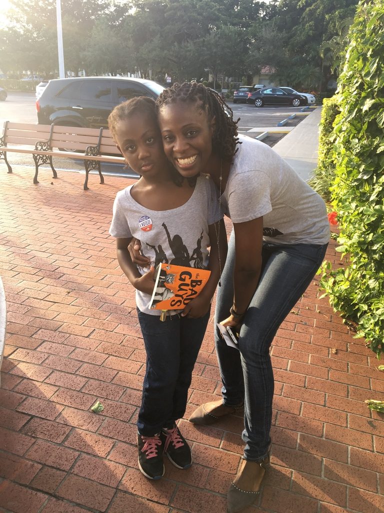 Law professor Osamudia James hugs her daughter, who she brought to the polls so her daughter would always remember her civic duty. Amanda Herrera // Assistant News Editor