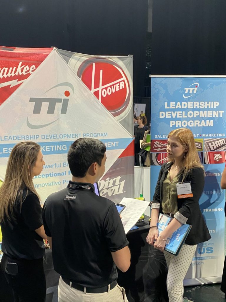 Senior Mckenzie Packer, on the far right, talks to territory managers of Techtronic Industries, from left to right, Sydni Wilkinson and Jesse Alejos on Feb. 25 at the Career Expo.