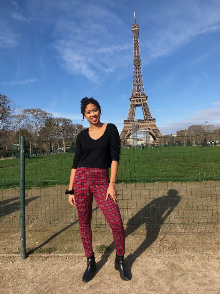 UM student Allegra Turner poses for a photo op in front of the Eiffel Tower during her semester abroad in Paris. Turner was one of 19 students from UM in the U-Paris program.