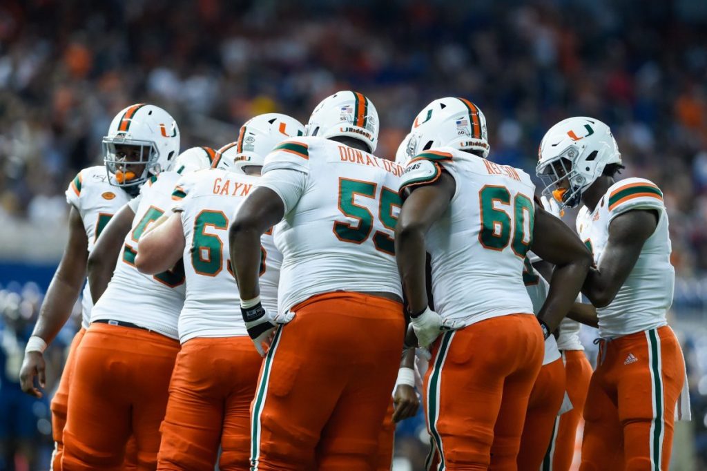 Members of the ‘Canes football team huddle during Miami’s game versus Florida International University at Marlins Park in Miami, FL on Nov. 23, 2019. The Hurricanes lost to the Panthers, 24-30.