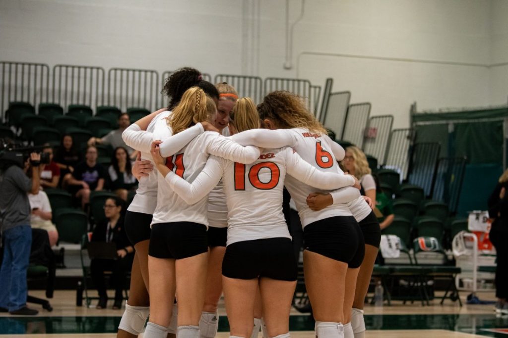 Members of the ‘Canes volleyball team huddle during their match versus NC State on Nov. 15, 2019, in the Knight Sports Complex.