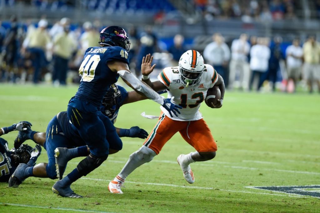 Deejay Dallas (13) stiff arms a defender during the game versus FIU on Saturday, Nov. 23, 2019 at Marlins Park.